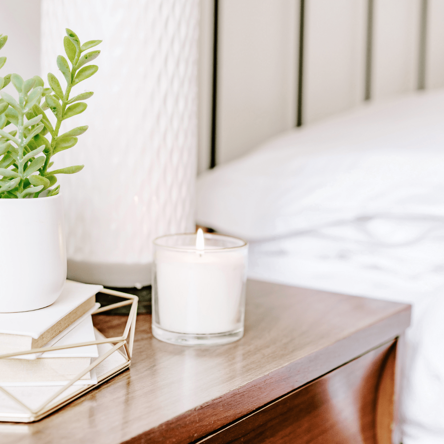 How to Get a Better Night's Sleep nightstand next to bed with candle