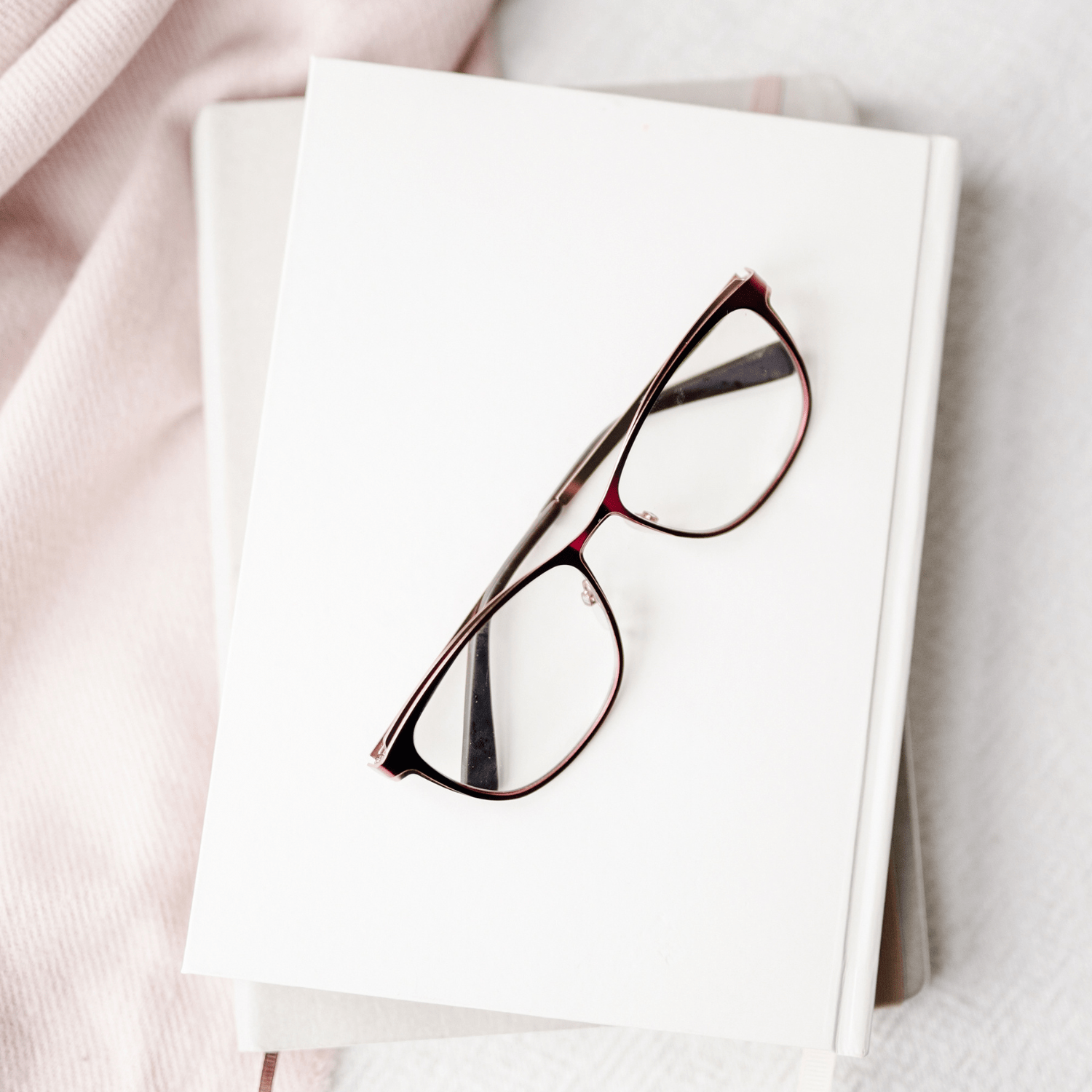 How to Get a Better Night's Sleep books stacked with glasses on top