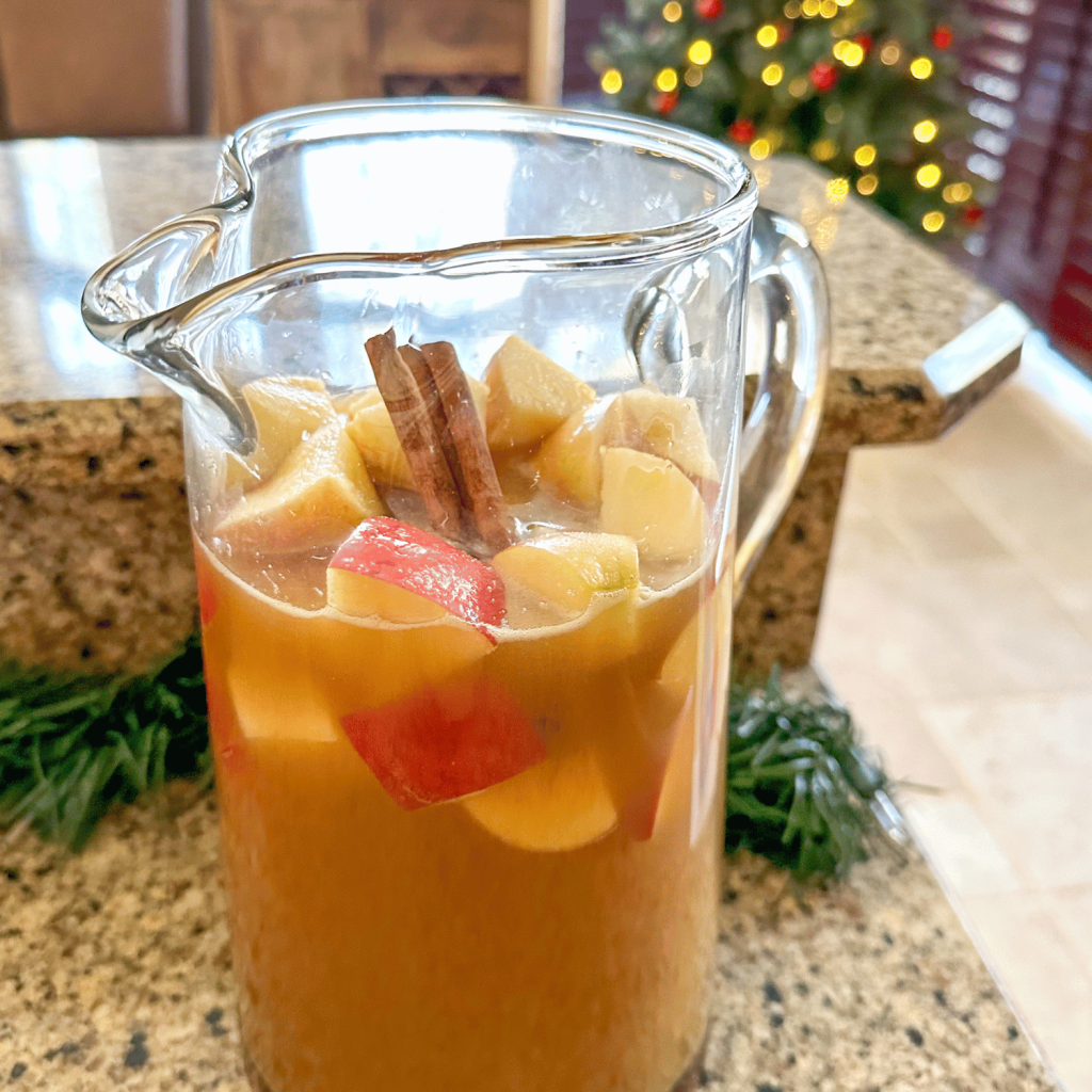 Caramel Apple Sangria in a pitcher on a counter in the kitchen