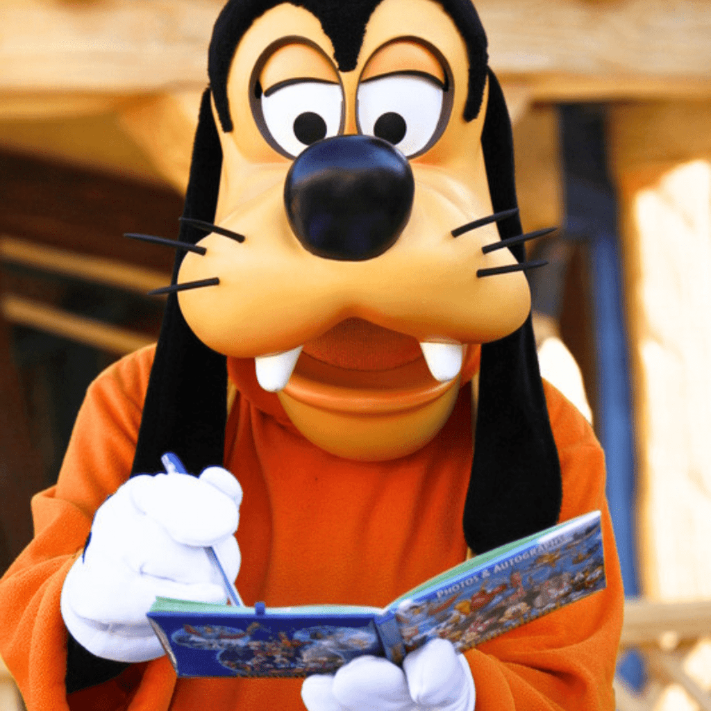 Disney Character Autographs Goofy signing autograph book at Disney