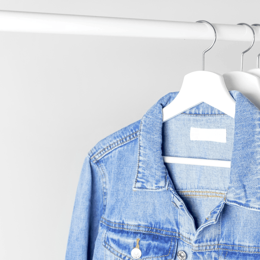 denim jacket hanging on clothing rack